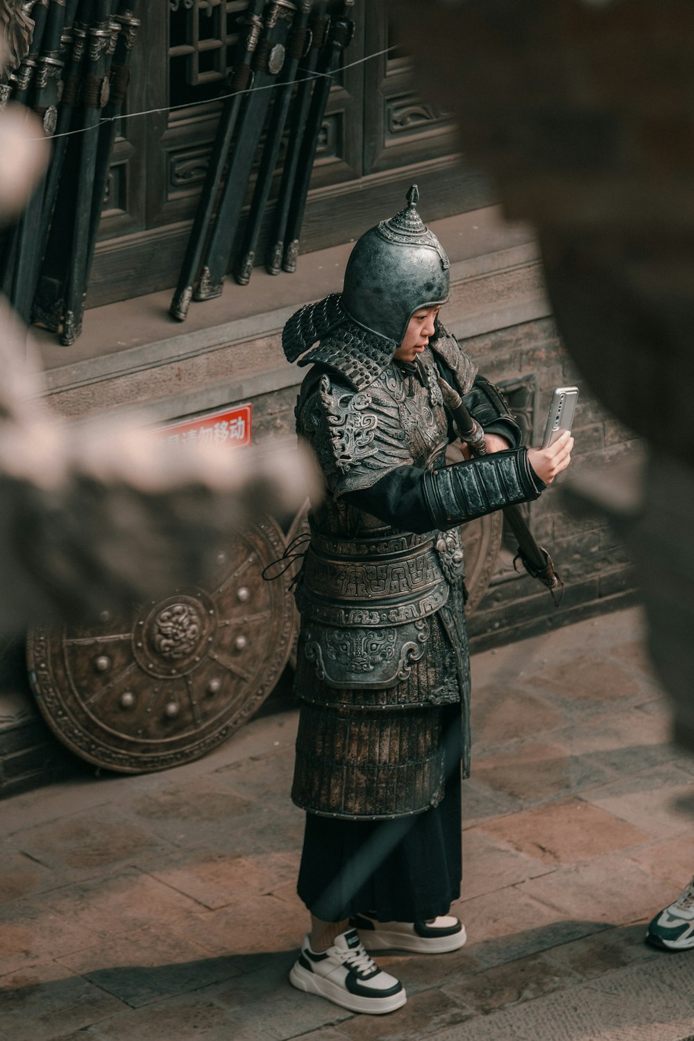 a man in a medieval costume looking at his cell phone