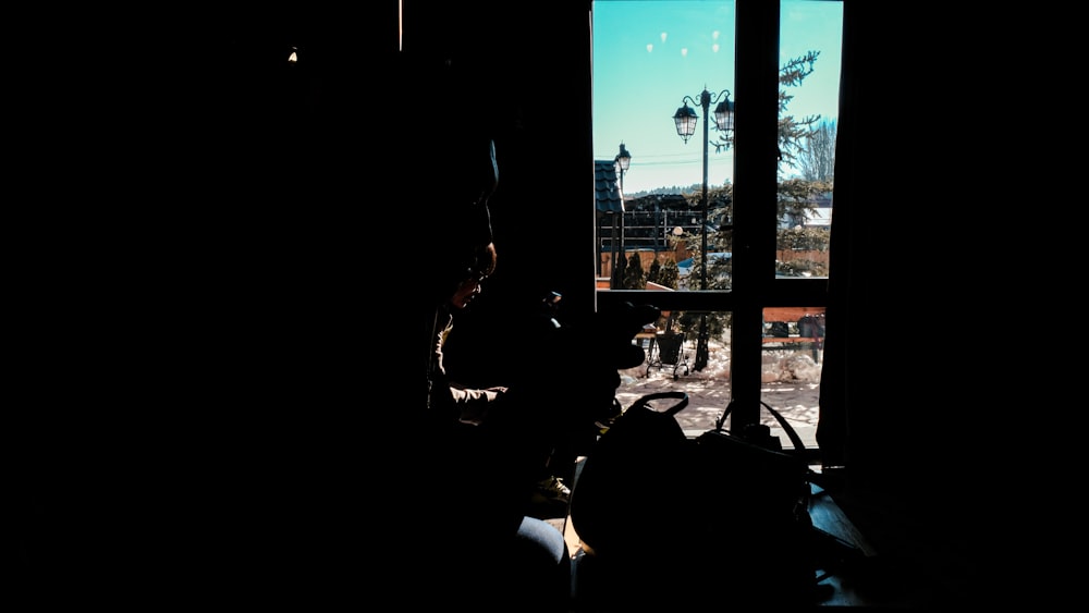 a cat sitting in a window sill in a dark room