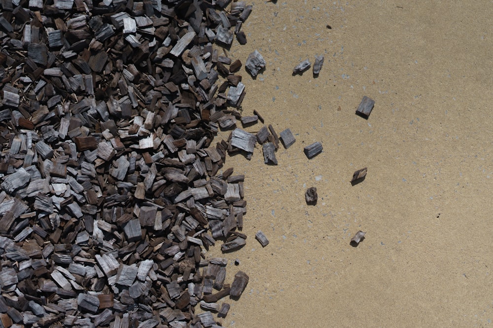 a pile of rocks sitting on top of a sandy beach