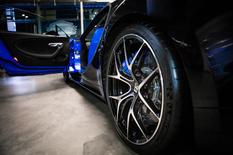 A set of premium car wheels displayed in a stylish showroom with elegant lighting.