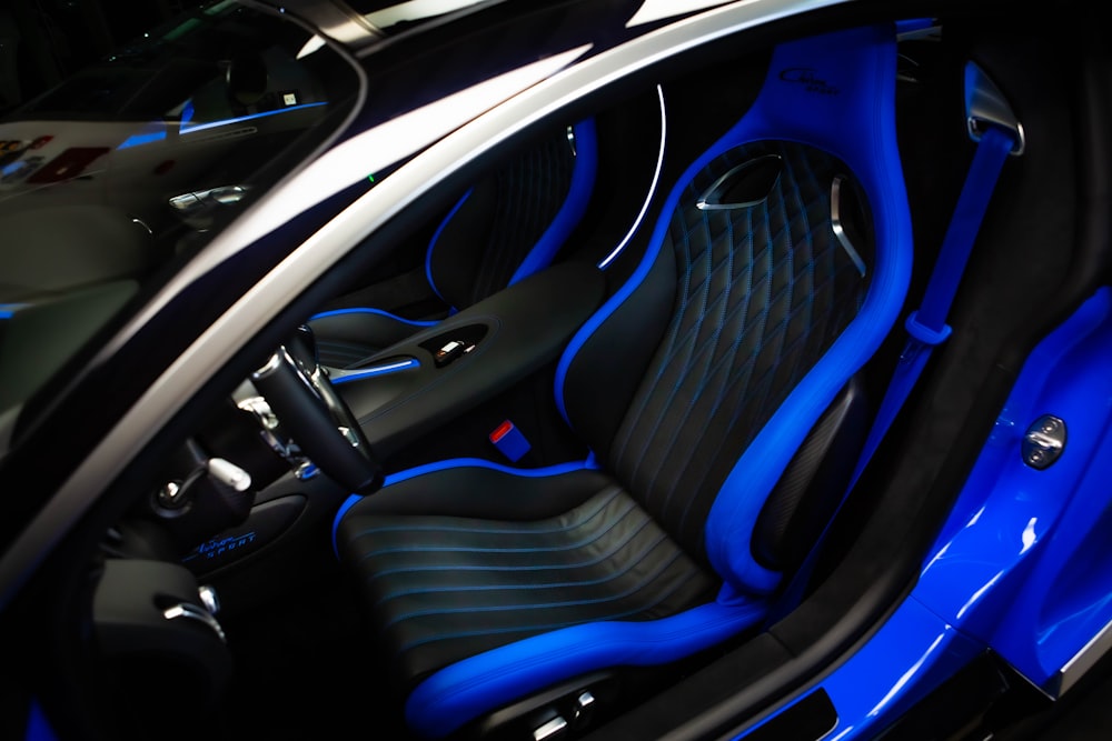 the interior of a car with blue and black seats