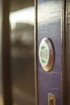 Close-up of a biometric fingerprint scanner installed on a modern office door.