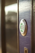 A sleek modern smart lock installed on a front door.