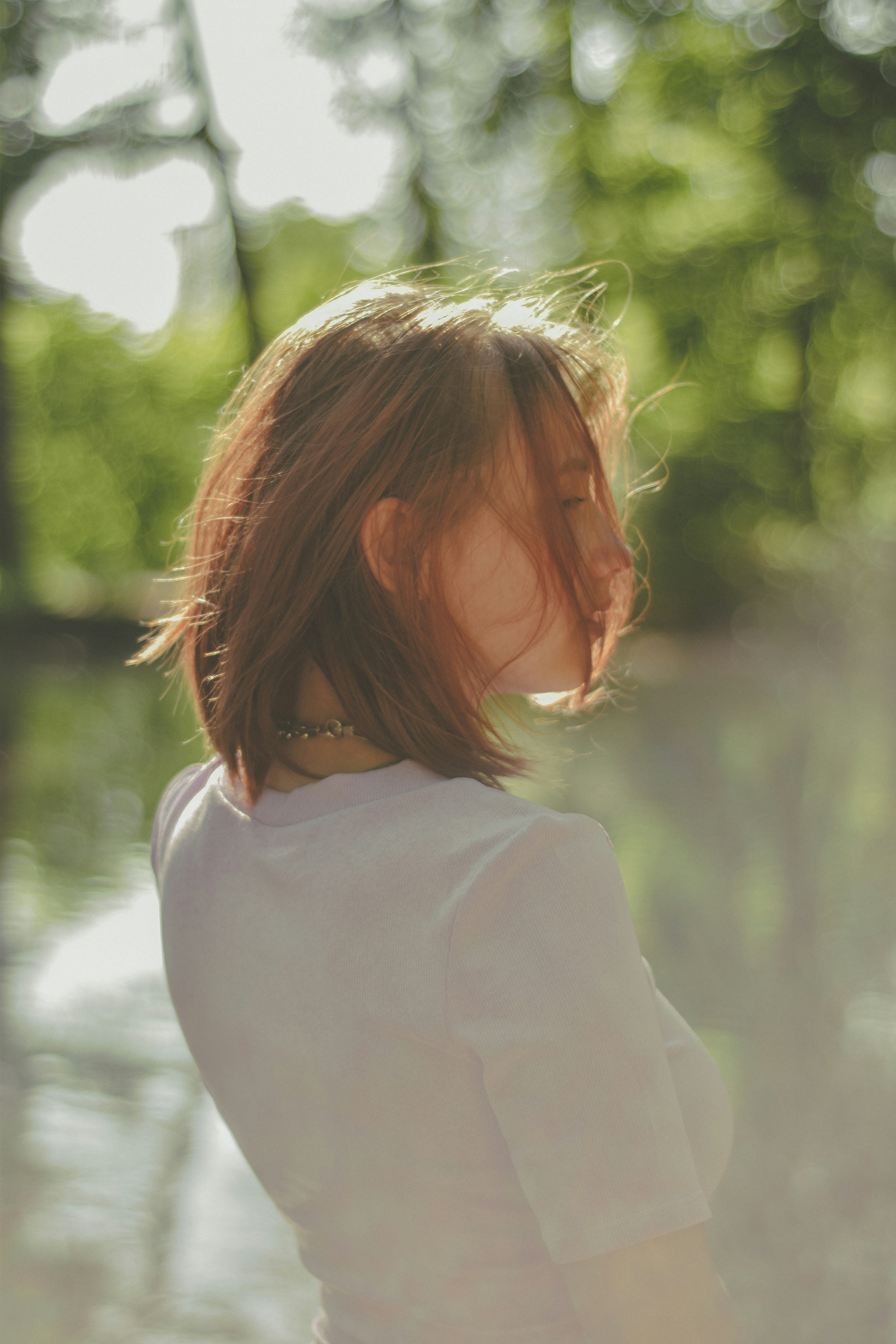 a woman standing in front of a body of water