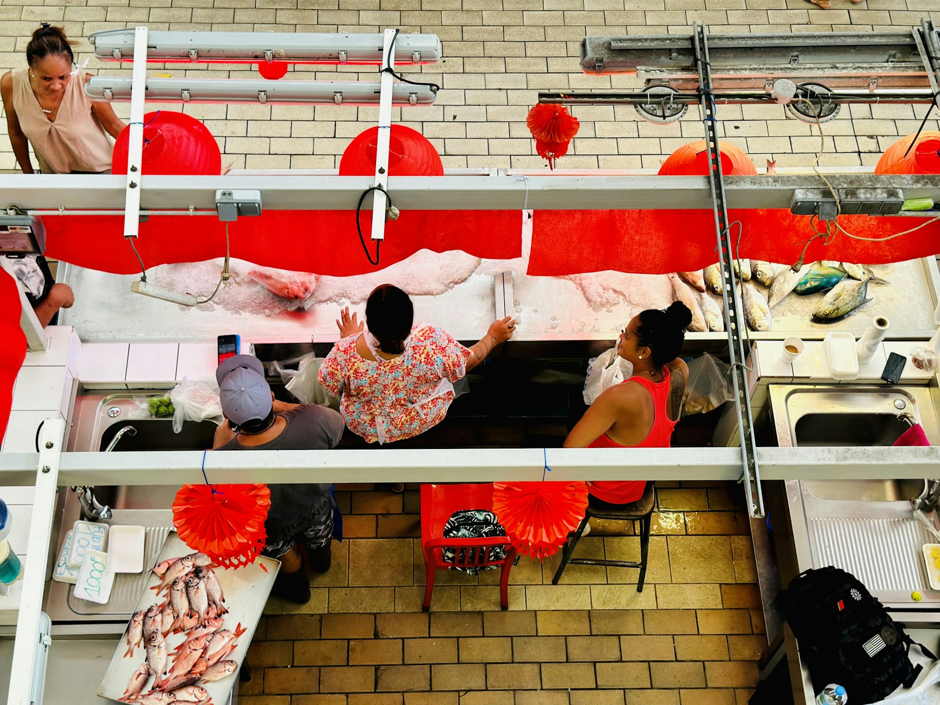 Group of people sitting at the Tahiti market, local atmosphere
