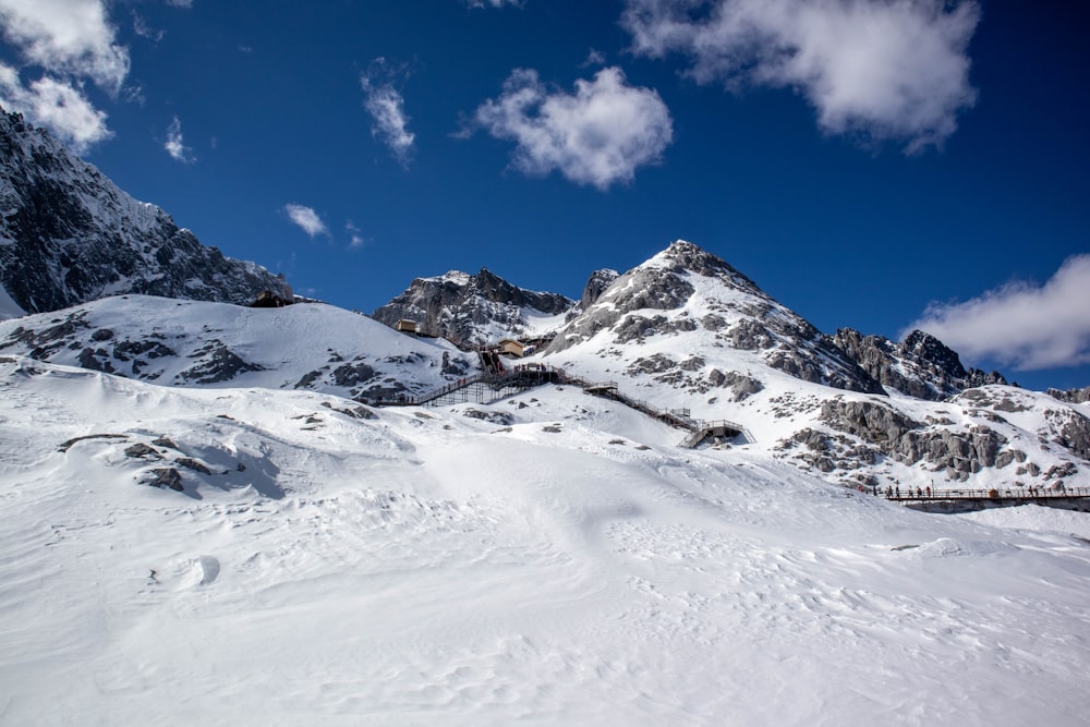 a mountain covered in snow under a blue sky