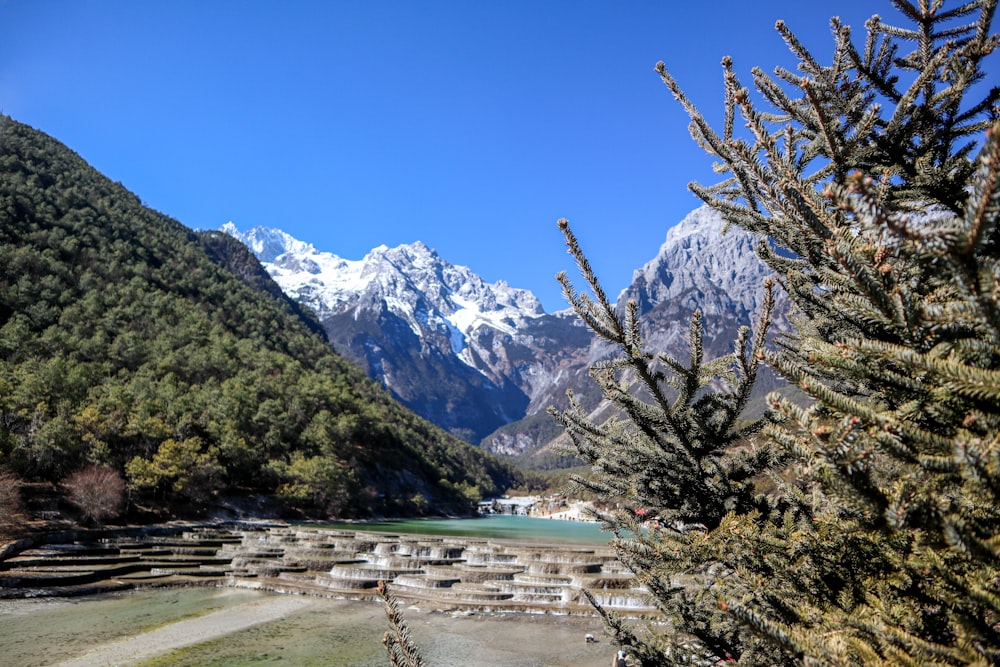 a view of a mountain range with a lake in the foreground