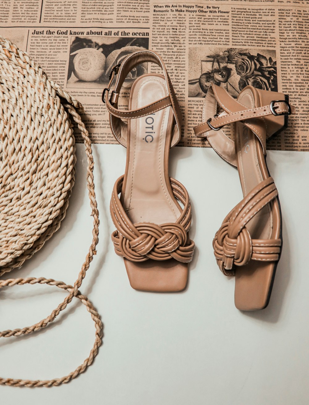 a pair of shoes sitting on top of a table next to a rope