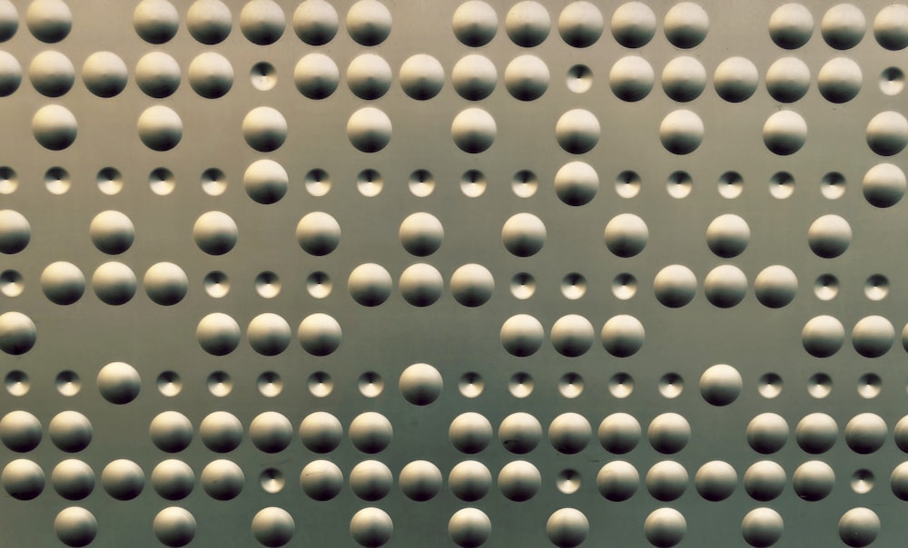 a close up of a perfored metal surface