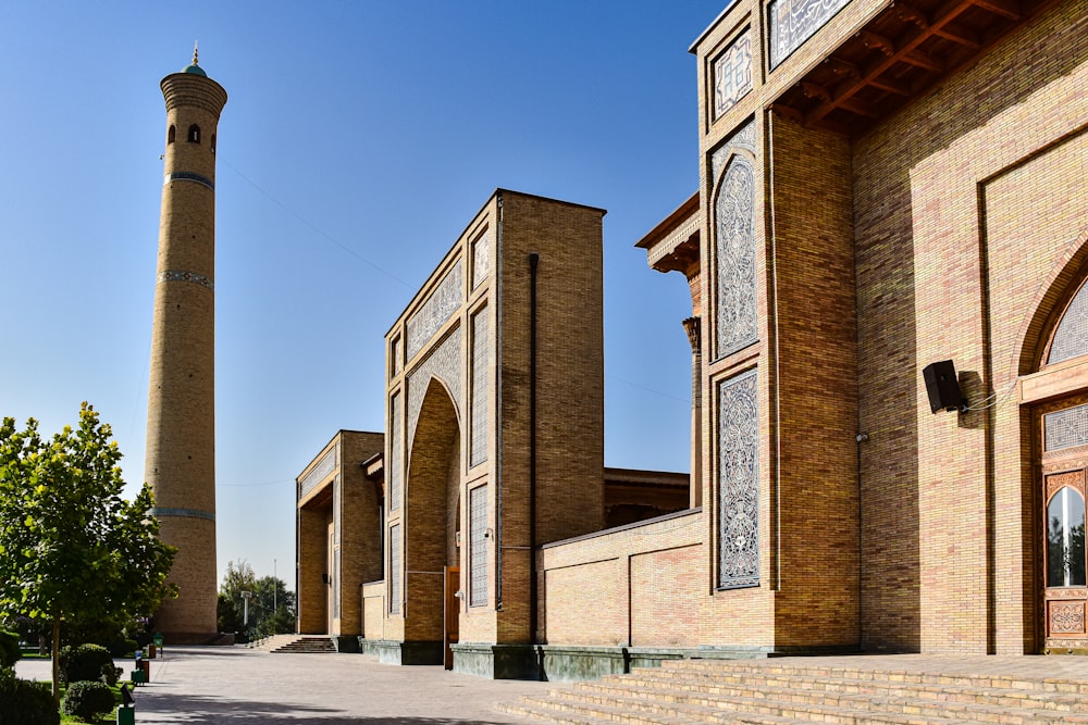 a tall brick building with a clock tower in the background