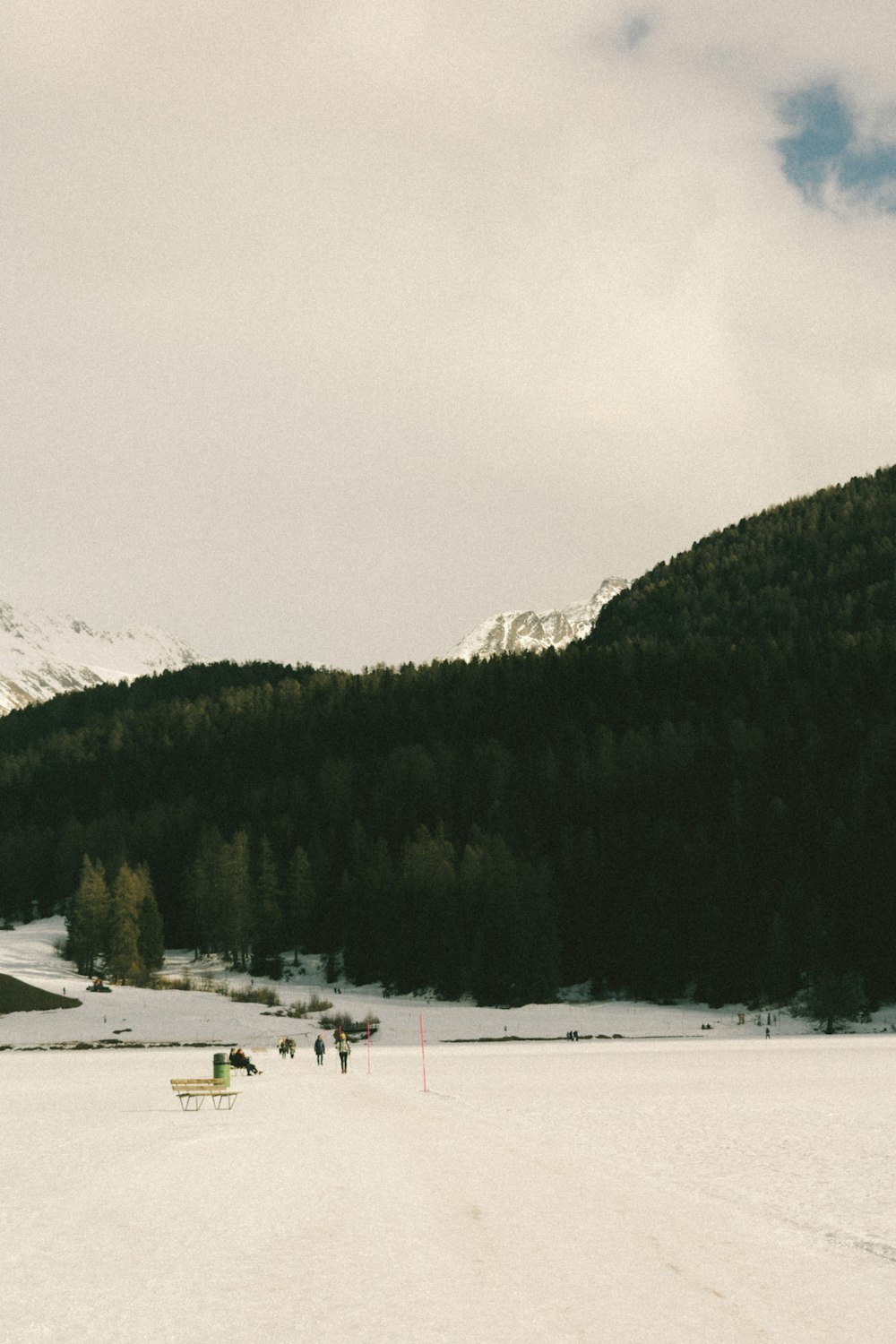 a group of people riding skis on top of a snow covered slope