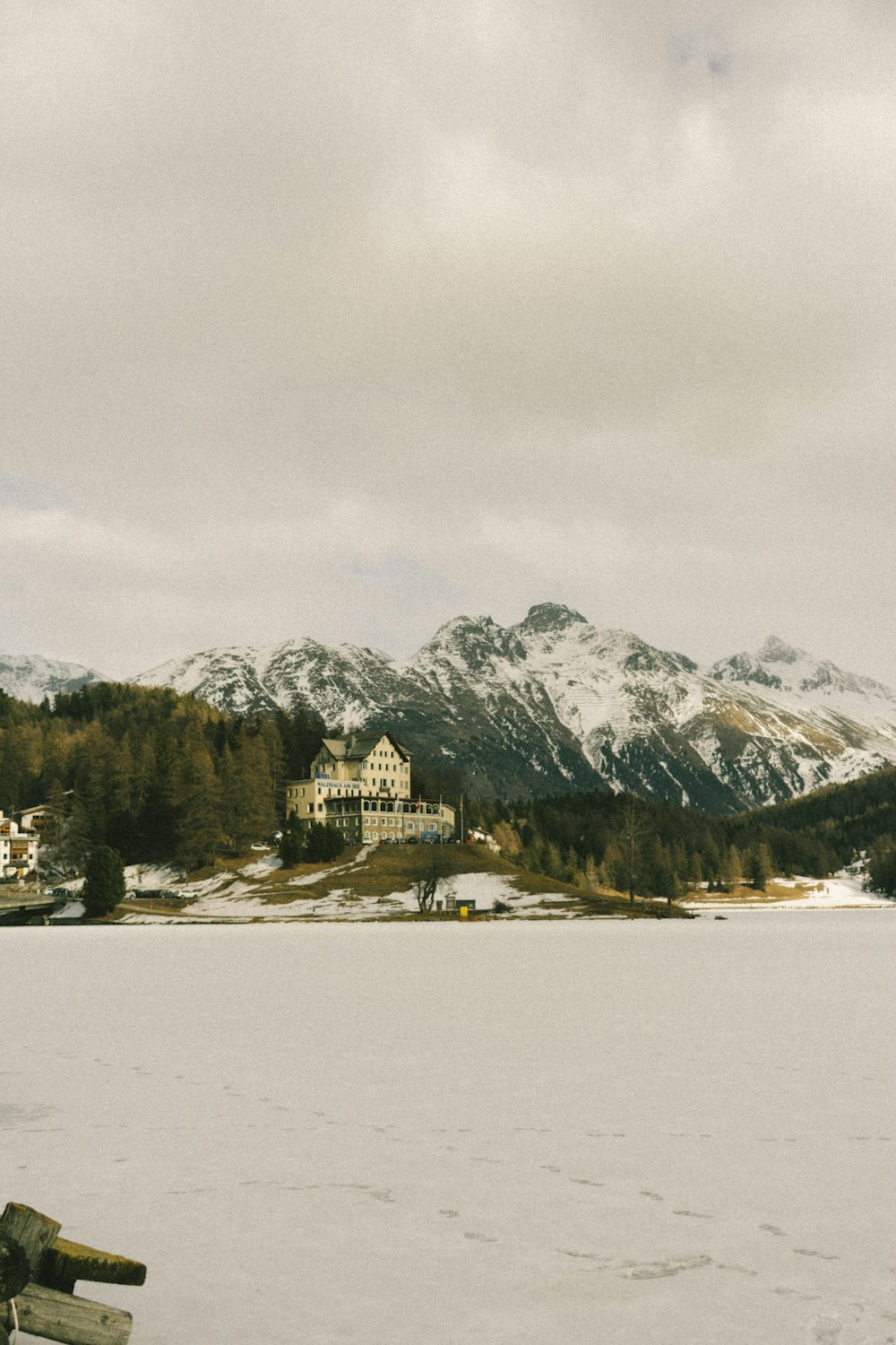 a boat sitting on top of a snow covered lake