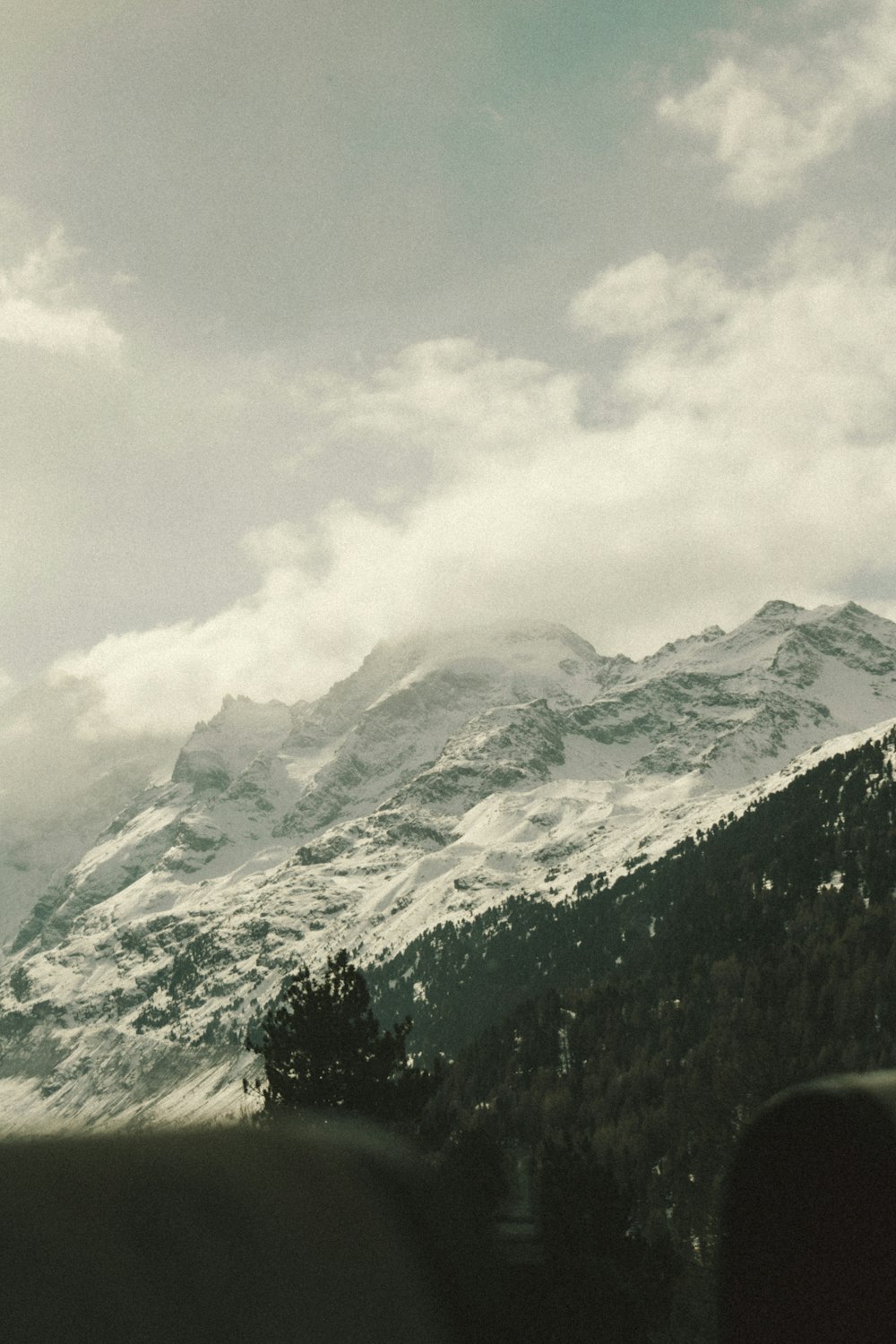 a view of a snowy mountain from a train window