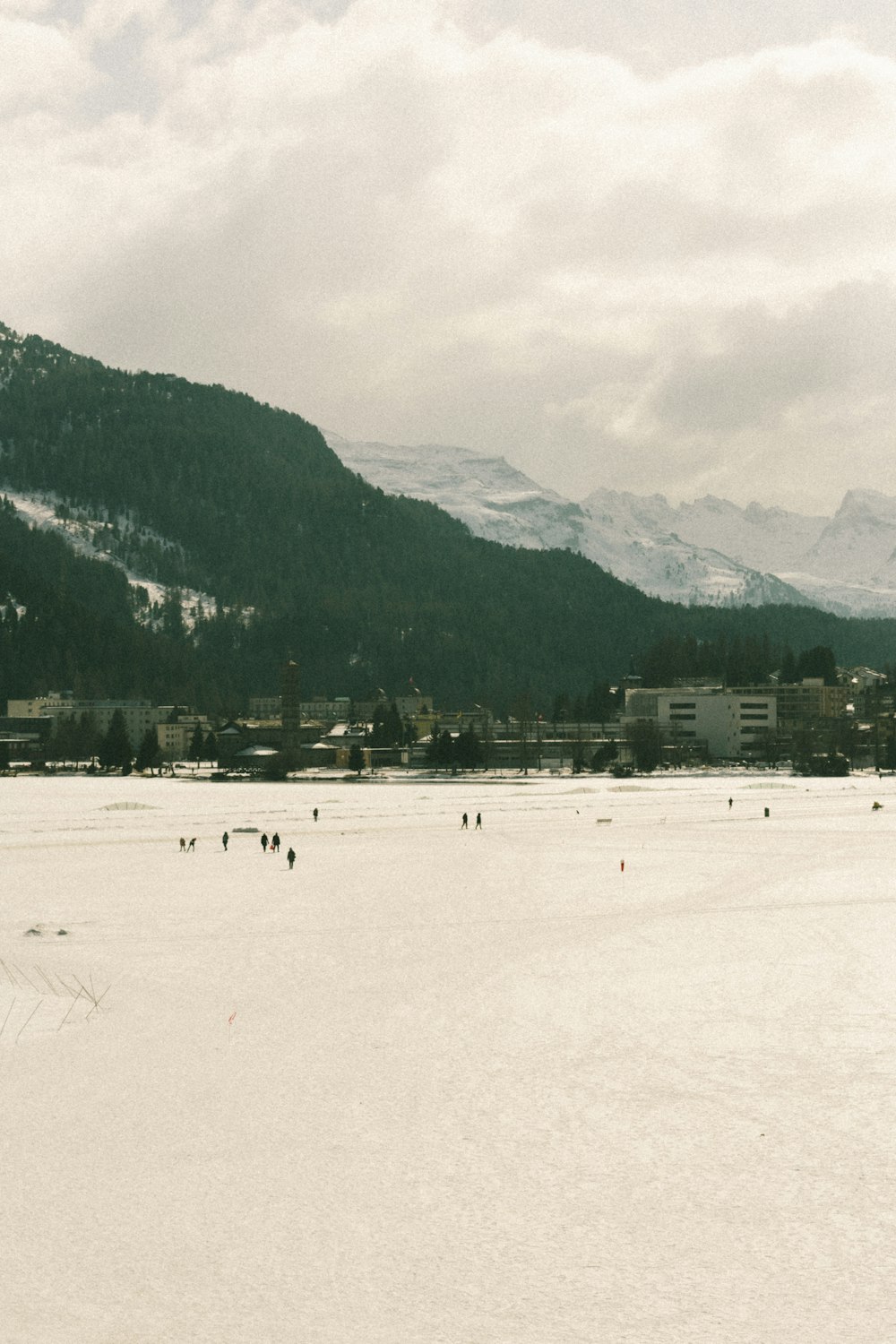 a group of people skiing across a snow covered field