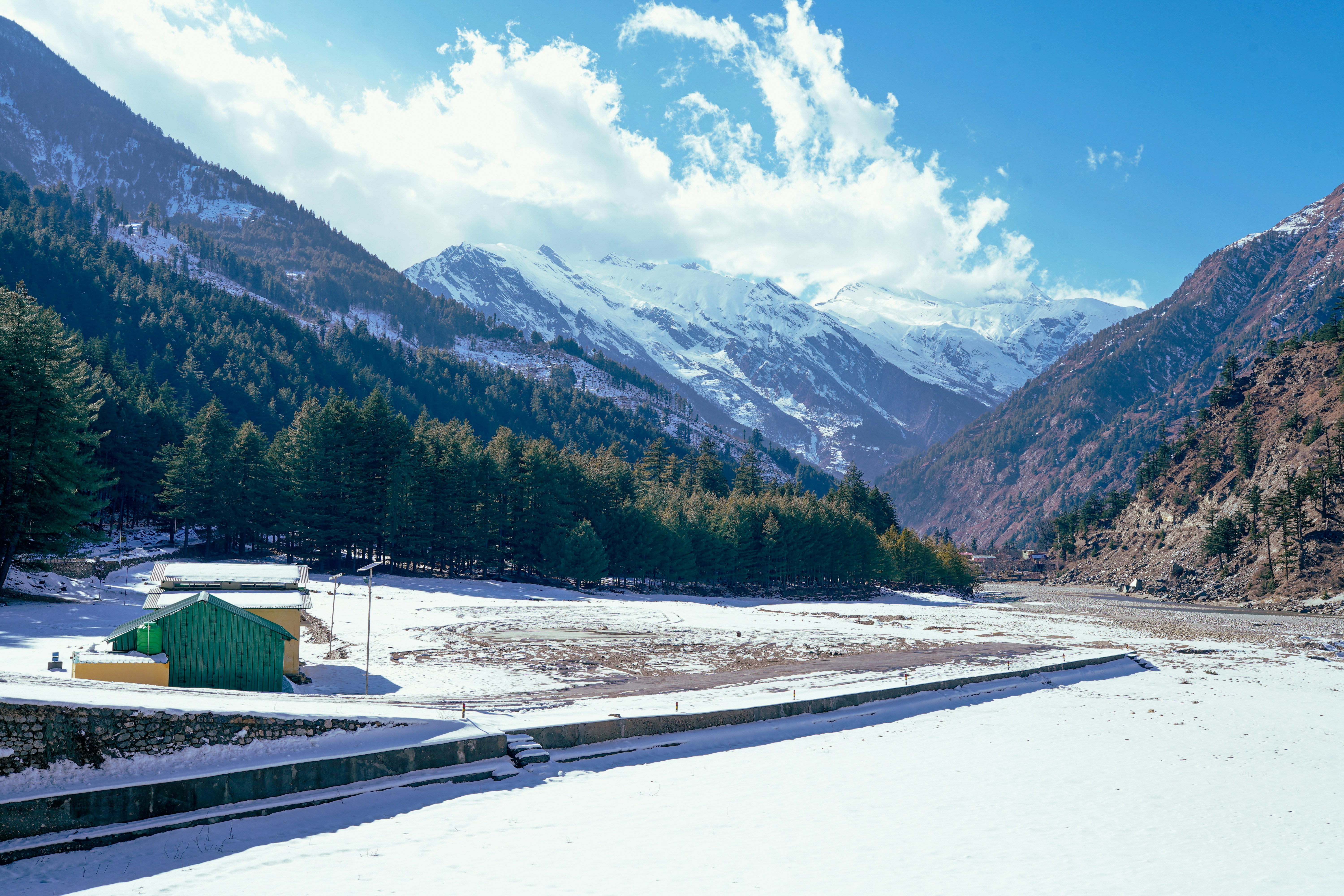 a snowy landscape with mountains in the background