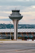 an airport with a control tower in the background