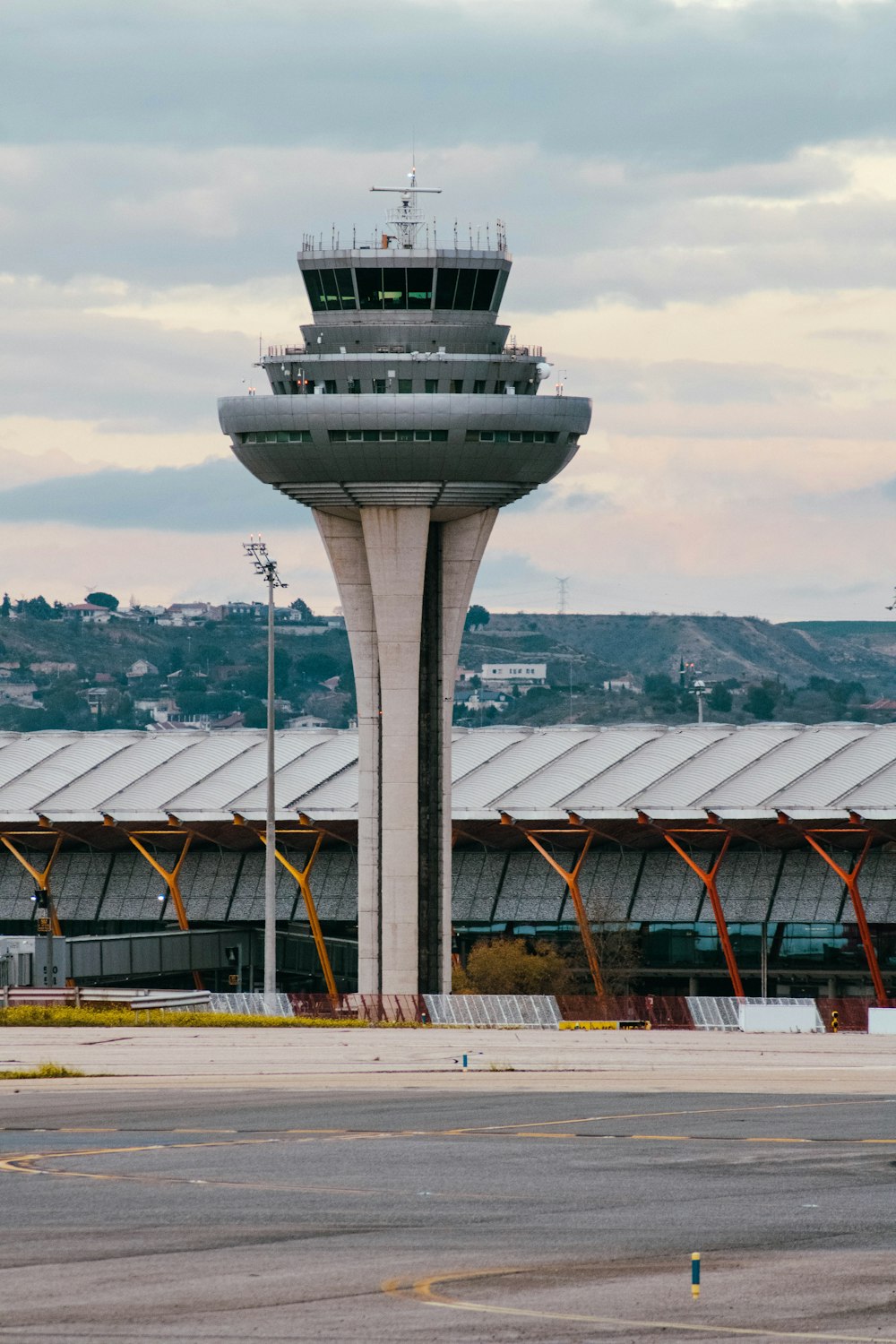 an airport with a control tower in the background