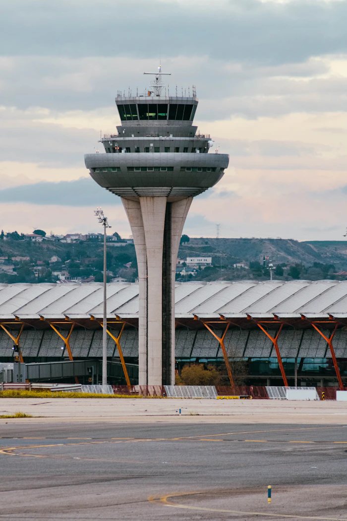 An airport control tower against a clear sky