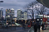 A sleek, modern skyline of London’s financial district at dusk, glowing with golden lights.