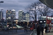 A cityscape of London highlighting the financial district at sunset.