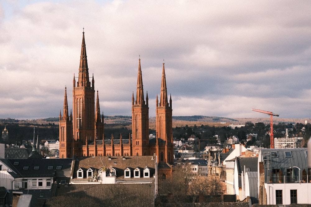 a large cathedral towering over a city under a cloudy sky