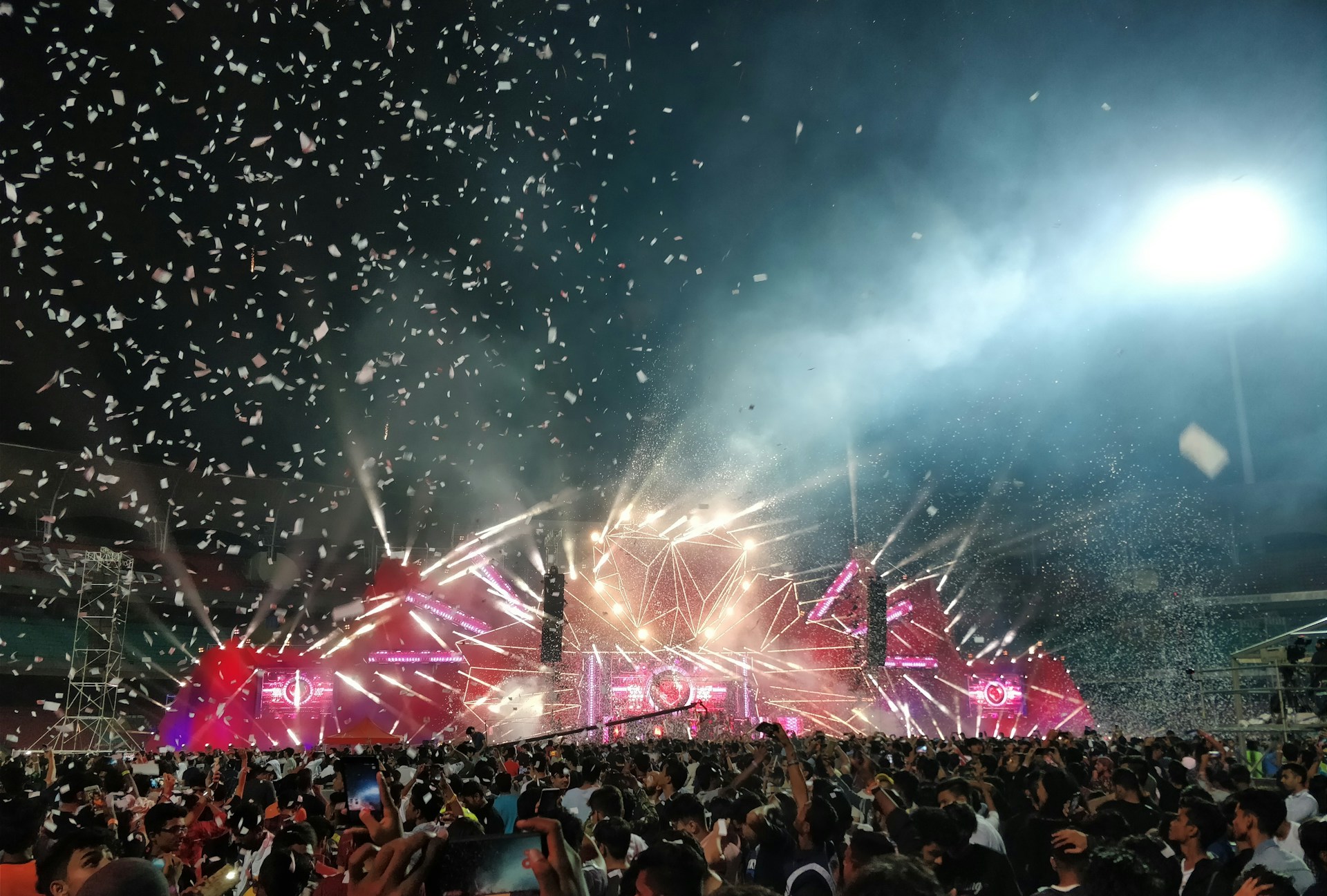 Crowd enjoying a night event with d-sastres under colorful stage lights, capturing the 80s and 90s rock vibe.