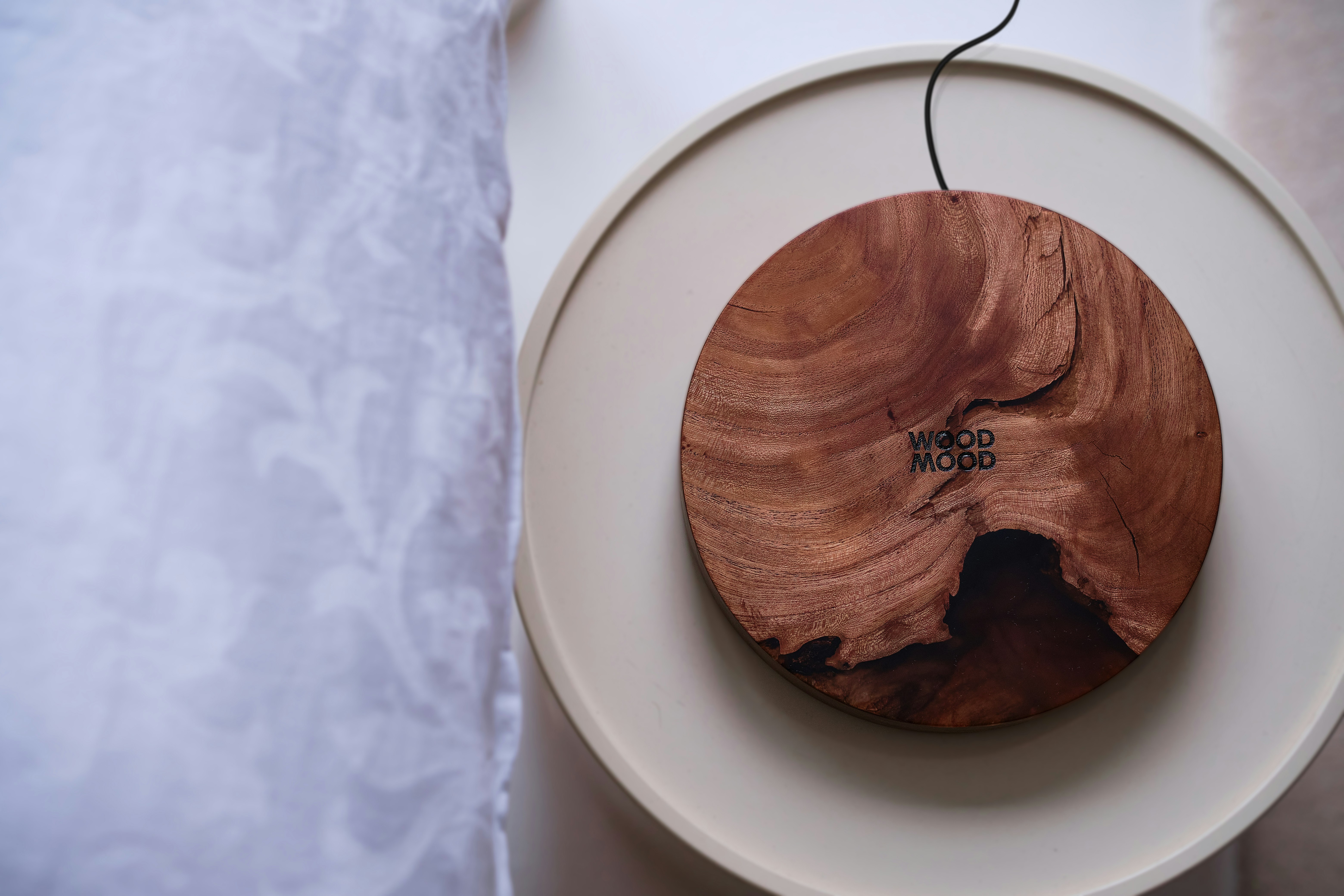 a wooden object on a white plate on a table