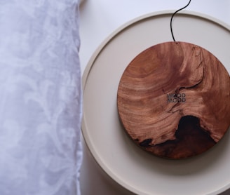 a wooden object on a white plate on a table
