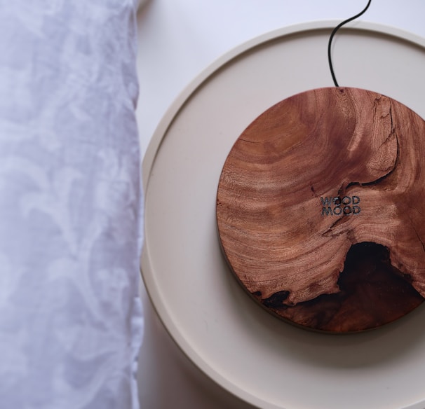 a wooden object on a white plate on a table