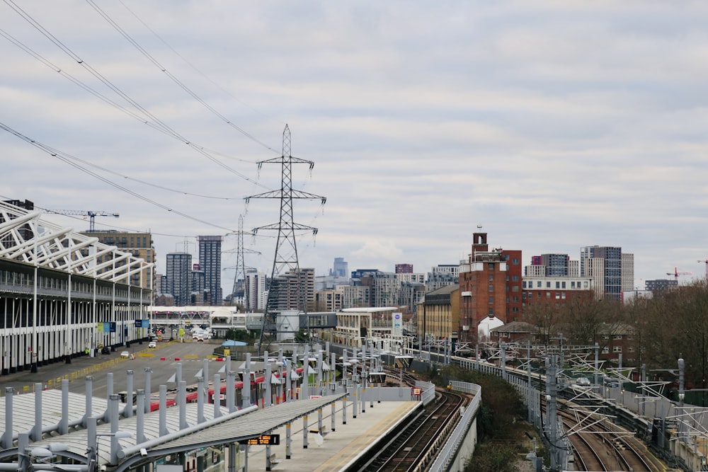 a view of a train station with a city in the background