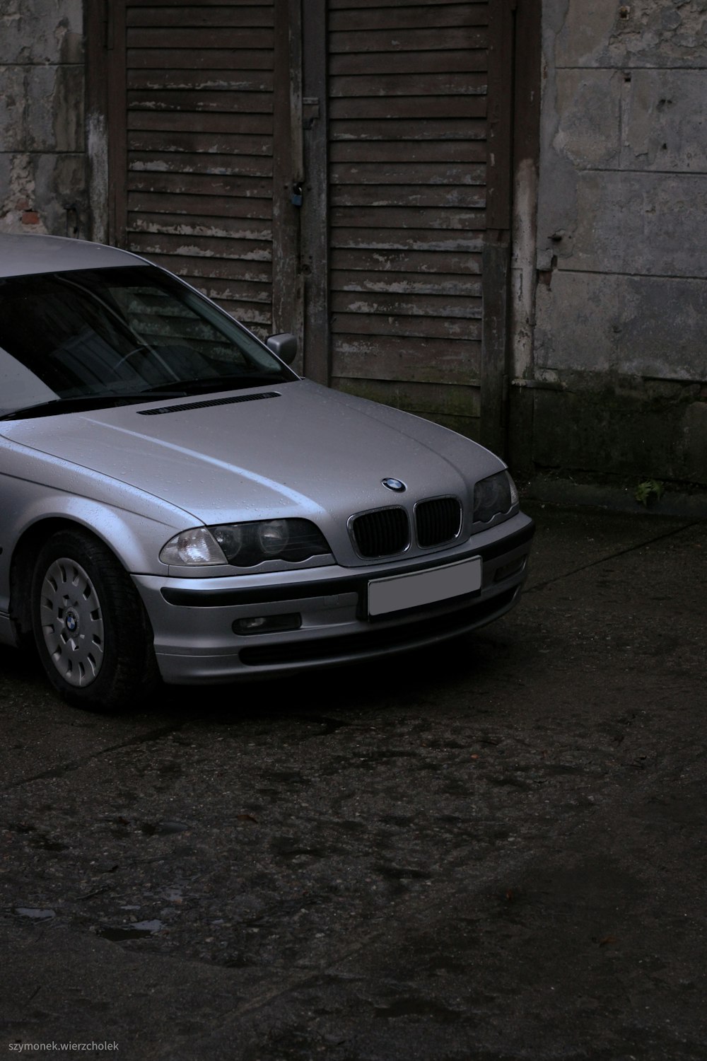 a silver car parked in front of a building