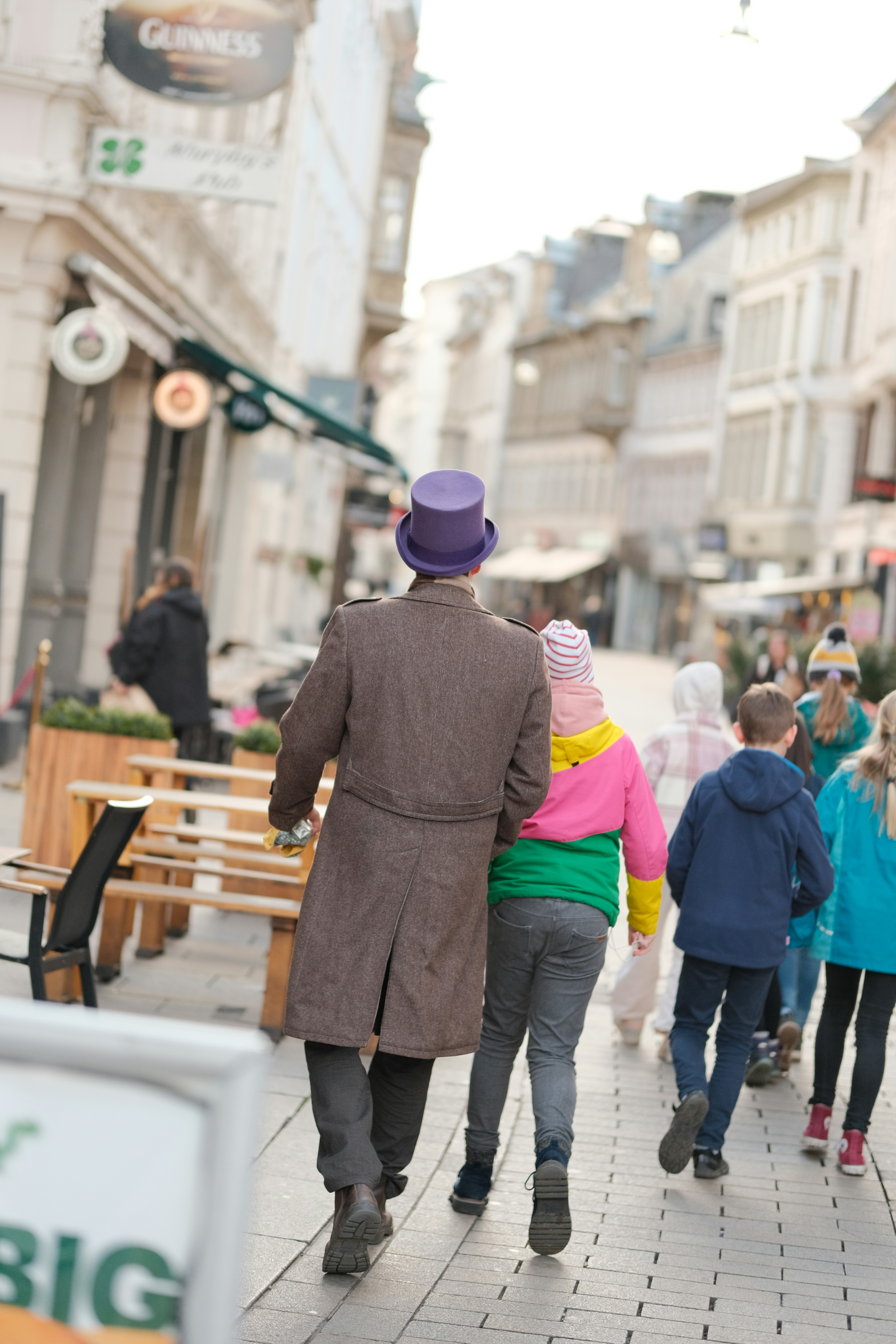 a group of people walking down a street