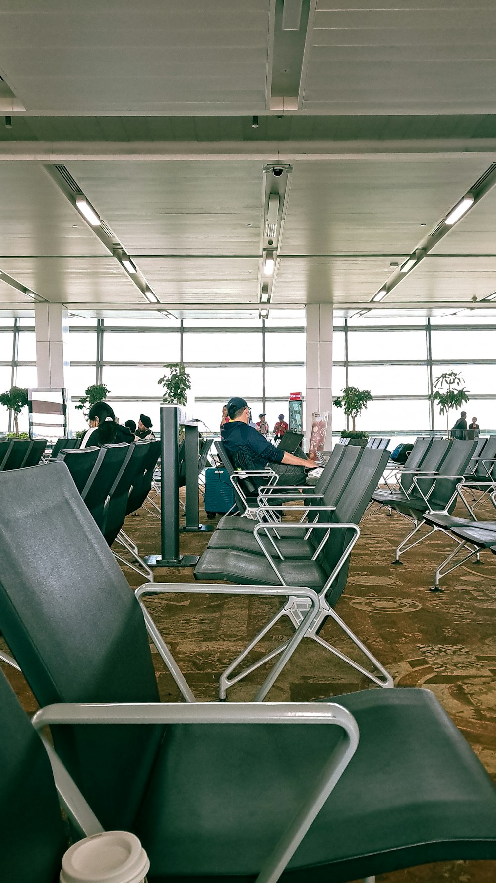 a group of people sitting in chairs in an airport