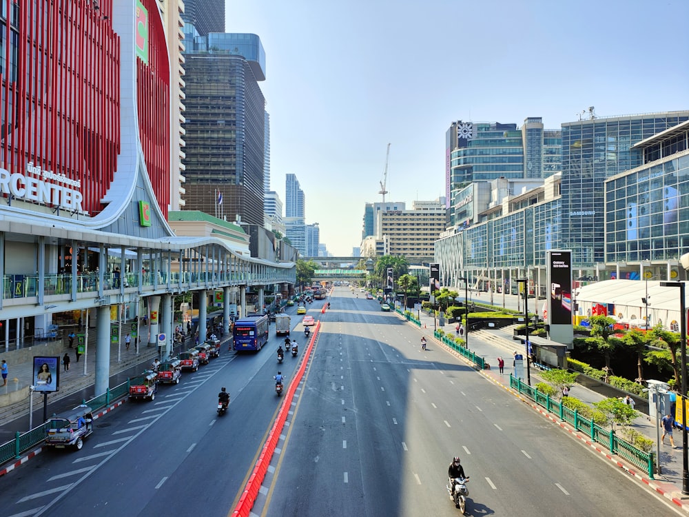 a city street filled with traffic next to tall buildings