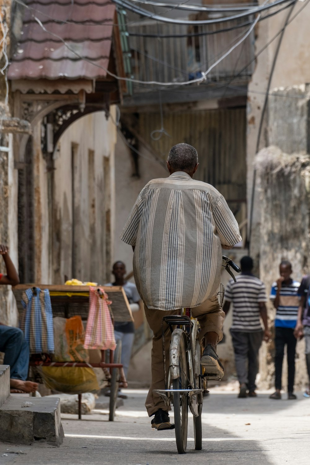 a man riding a bike down a street