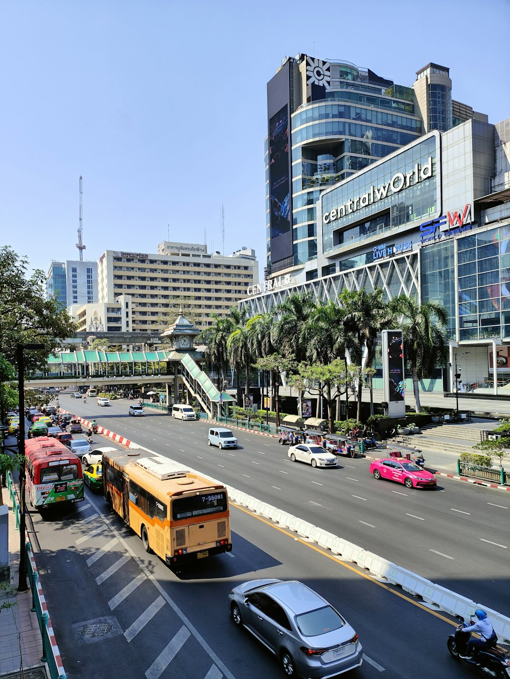 a city street filled with traffic next to tall buildings