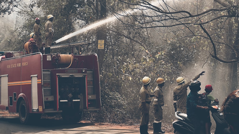 a group of people standing around a fire truck