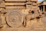 a statue of a horse with a wheel on it's back