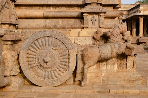 a statue of a horse with a wheel on it's back