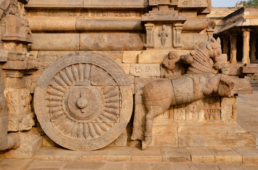 a statue of a horse with a wheel on it's back