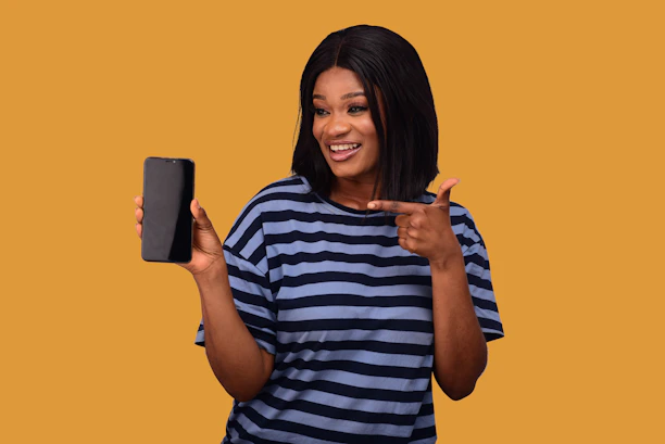 A cheerful small business owner using a smartphone app with a bright blue and yellow interface.