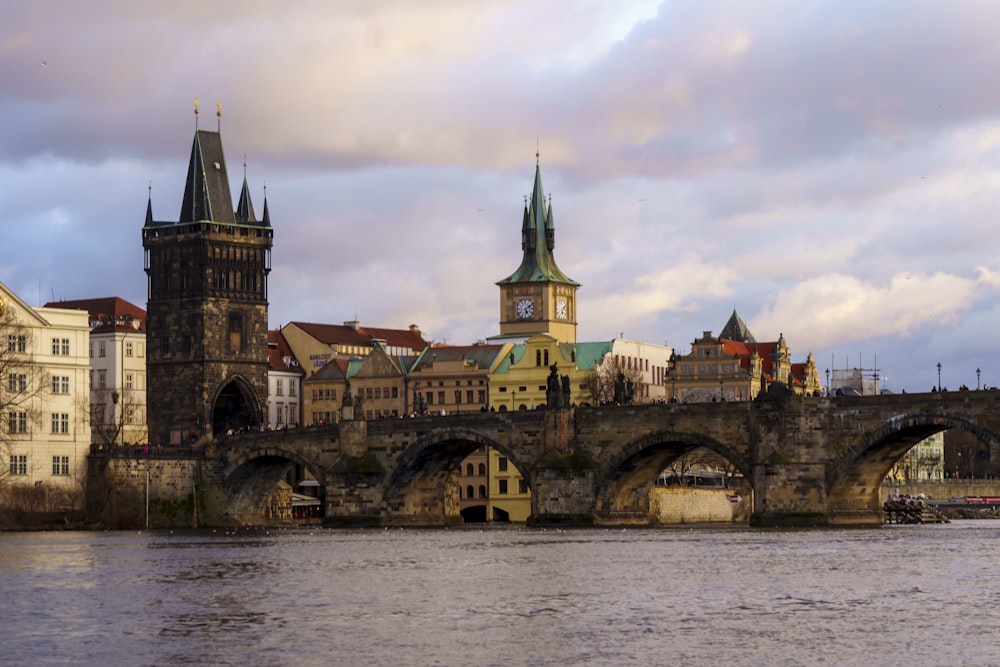 a bridge over a body of water with a castle in the background