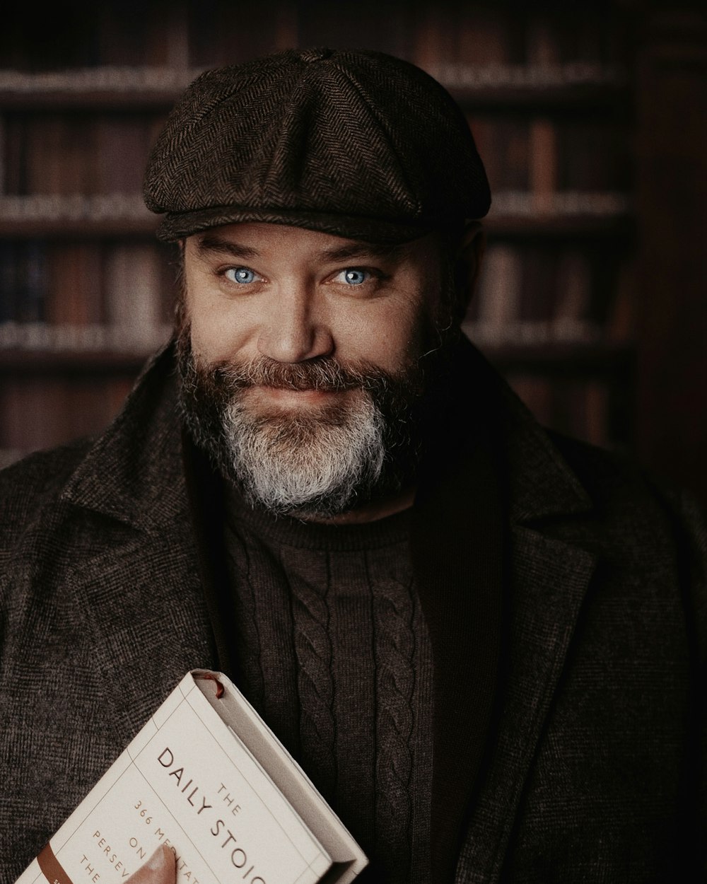 a man with a beard holding a book