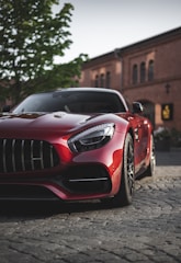 A shiny red sports car ready for a weekend drive.