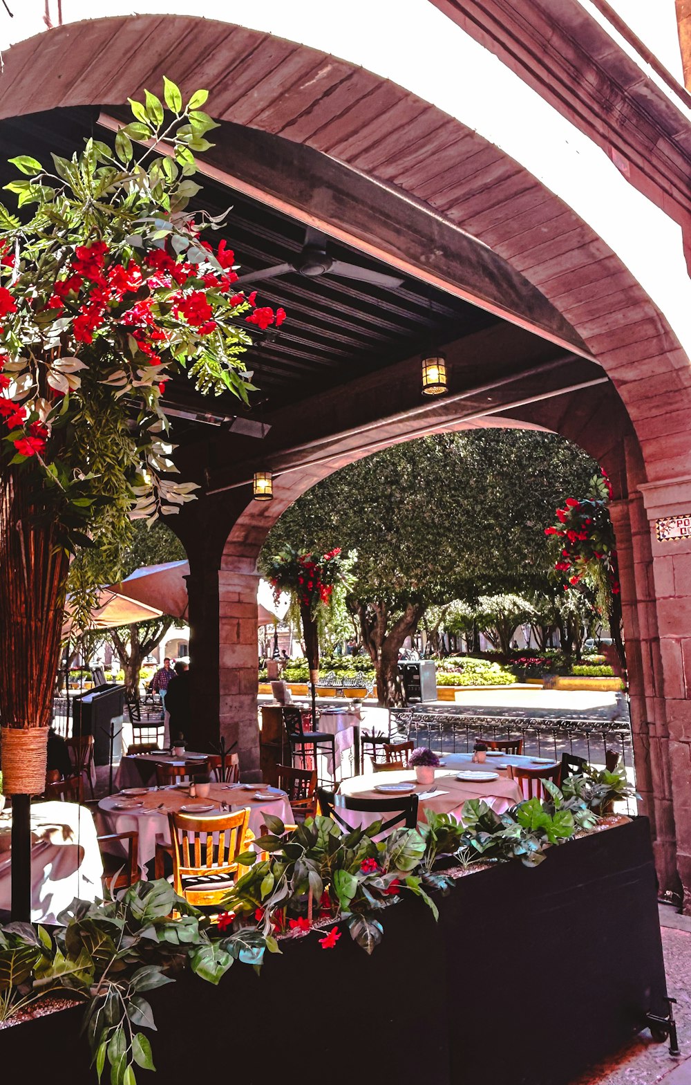 a covered patio with a table and chairs