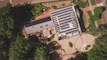 An aerial view of a factory with rooftop solar panels paired with a liquid-cooled energy storage system.
