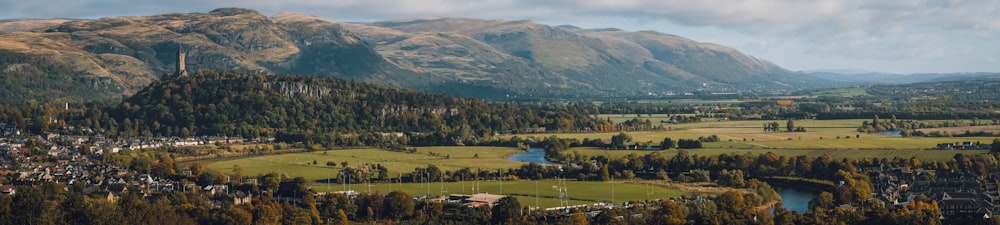 a scenic view of a valley surrounded by mountains