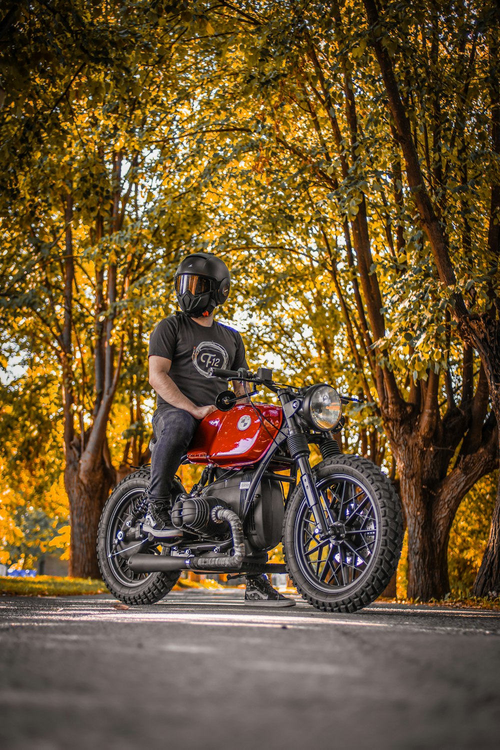 a man is sitting on a red motorcycle