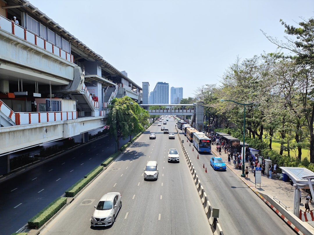 a city street filled with lots of traffic next to tall buildings