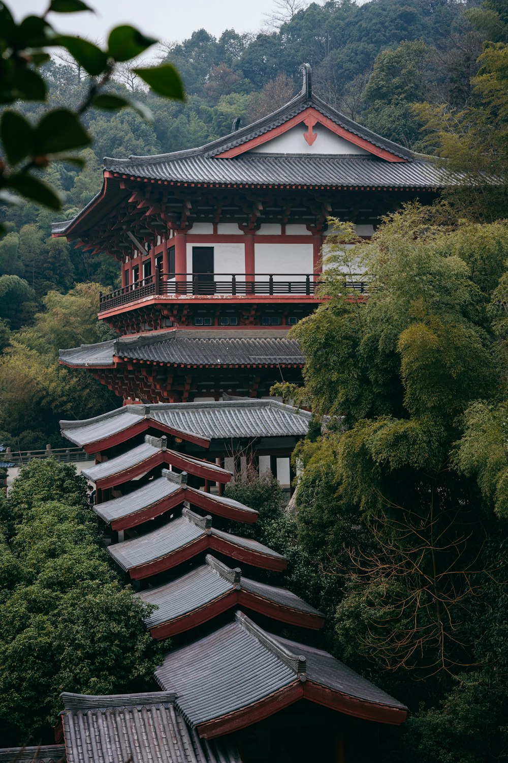 a tall building with a lot of trees in front of it